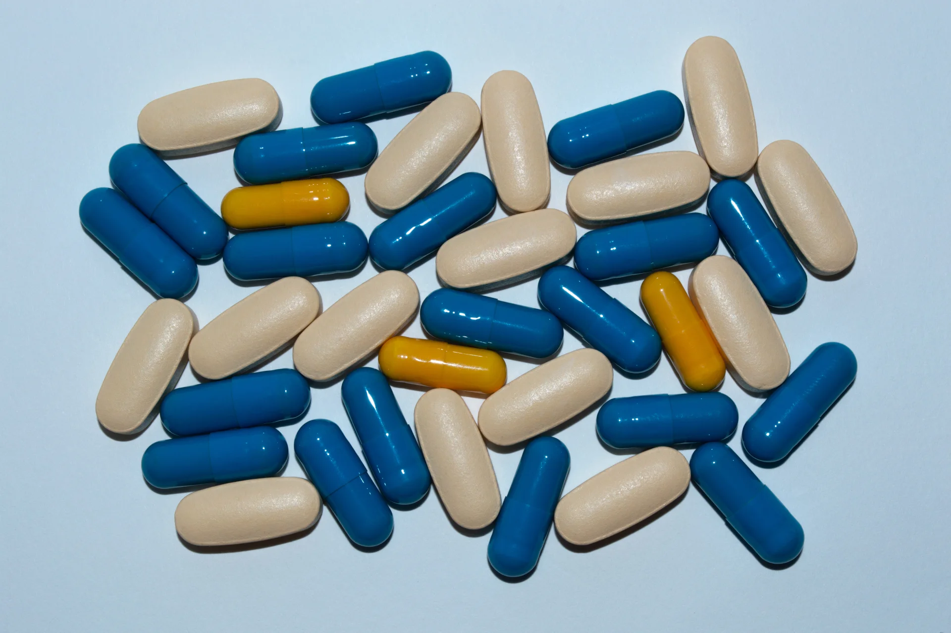 The capsules are scattered on a white surface.