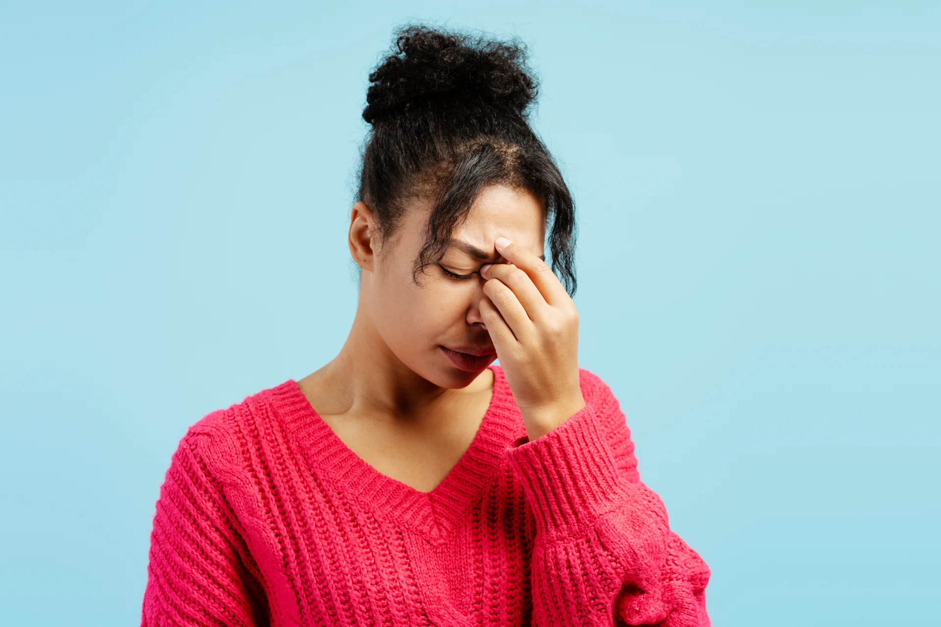 woman with headache, blue background