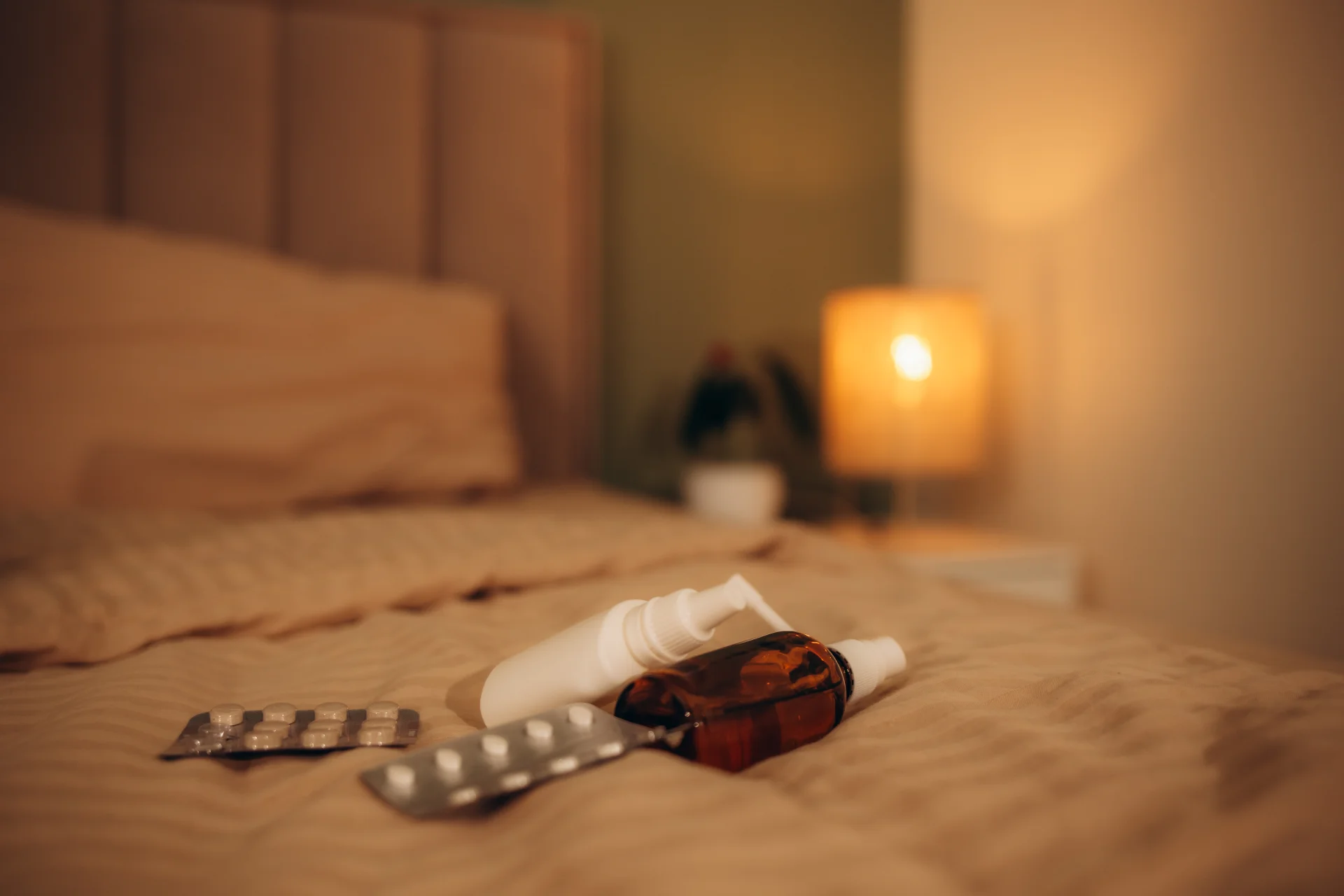 several medications scattered across a small part of the bed