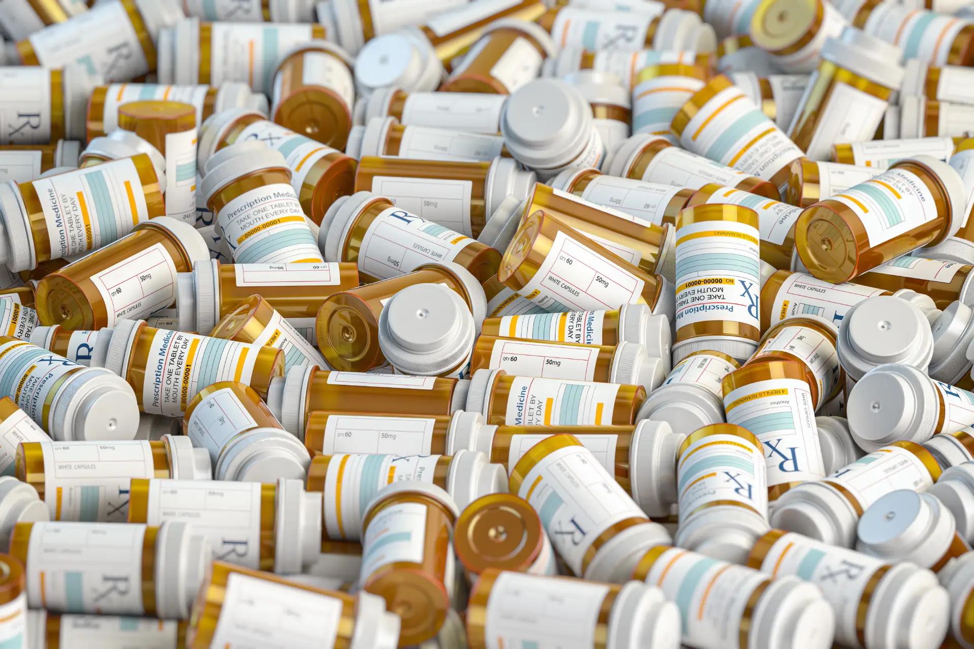 A close-up of prescription pill bottles scattered on a table with a warning label in focus.