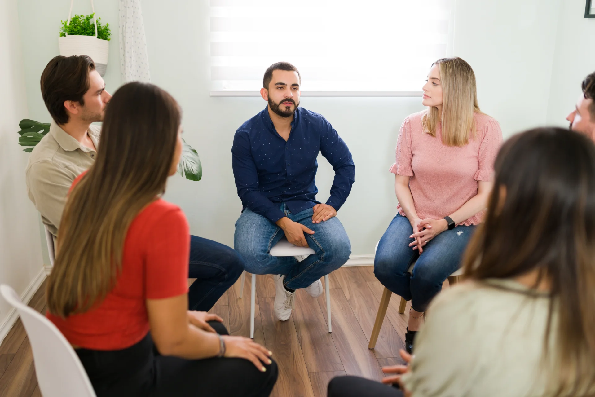 people in a support circle, listening to others
